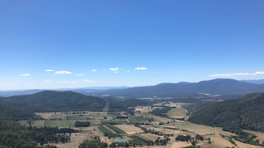 A view from above the valley, where there are farms and vineyards.