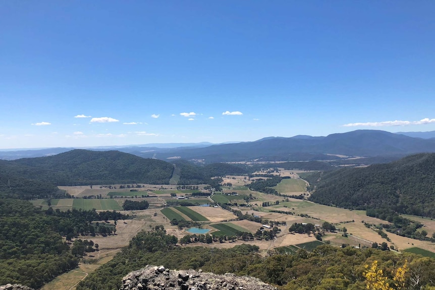 A view from above the valley, where there are farms and vineyards.