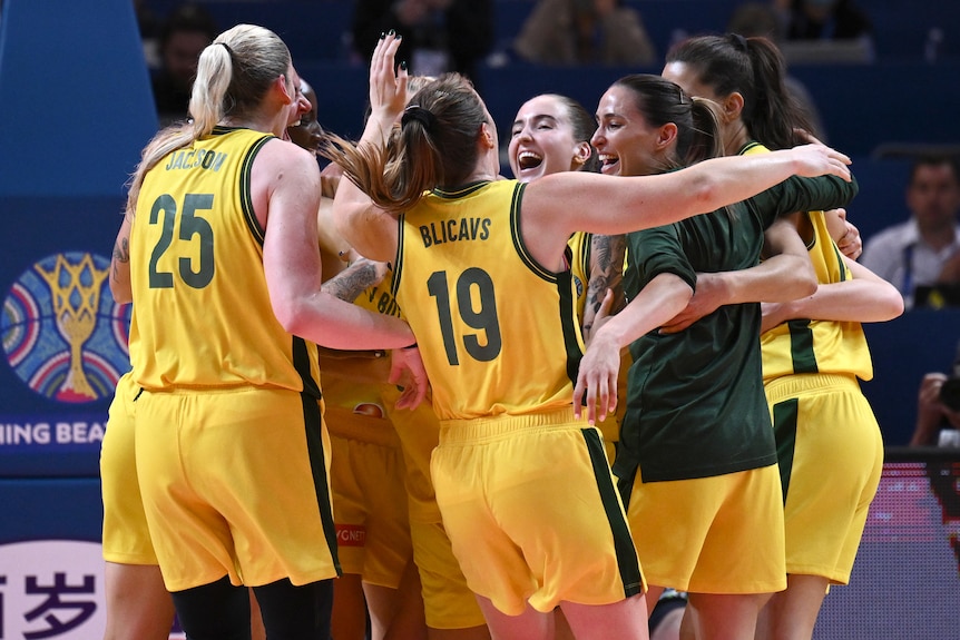 Opals players embrace as they celebrate winning bronze at the World Cup.