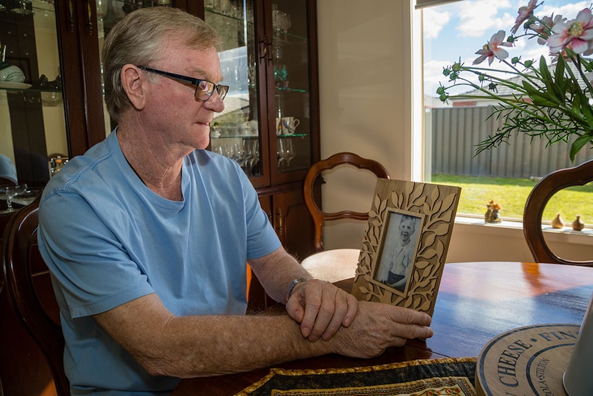 John Glynn with a photo of himself as a child