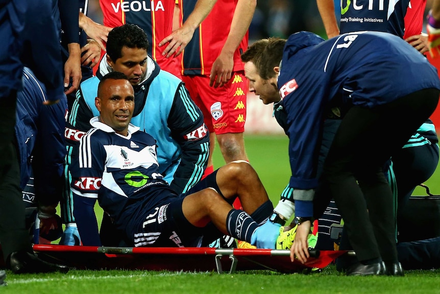 Melbourne Victory's Archie Thompson is stretchered off