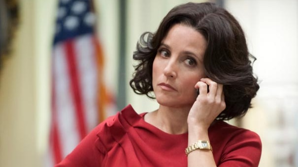 Julia Louis-Dreyfus, as Selina Meyer, in a room in the White House with an out-of-focus American flag behind her.
