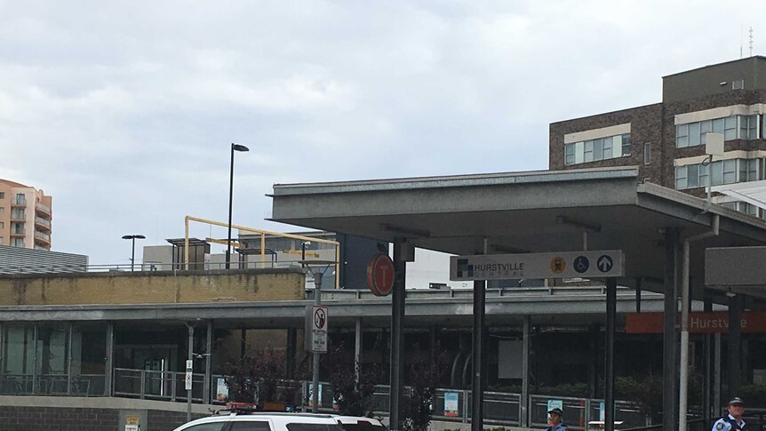 Police tape across an entrance to Hurstville train station.