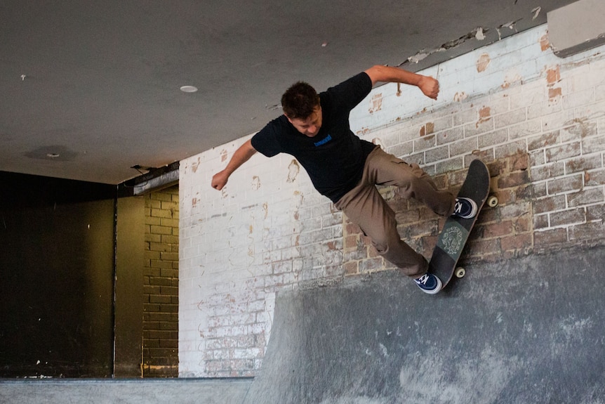 Ando defies gravity, skating up a wall.