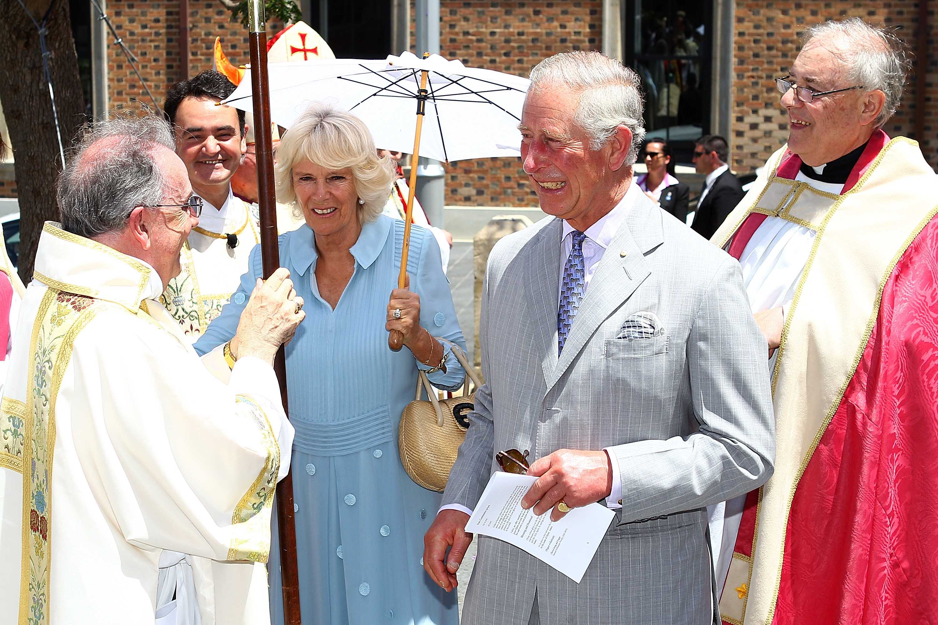 Prince Charles and his wife Camilla speak with members of the clergy