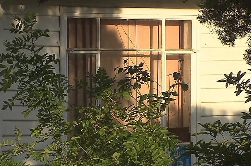 A boarded up window of a house in Mitcham, in Melbourne's east, where a body was found.