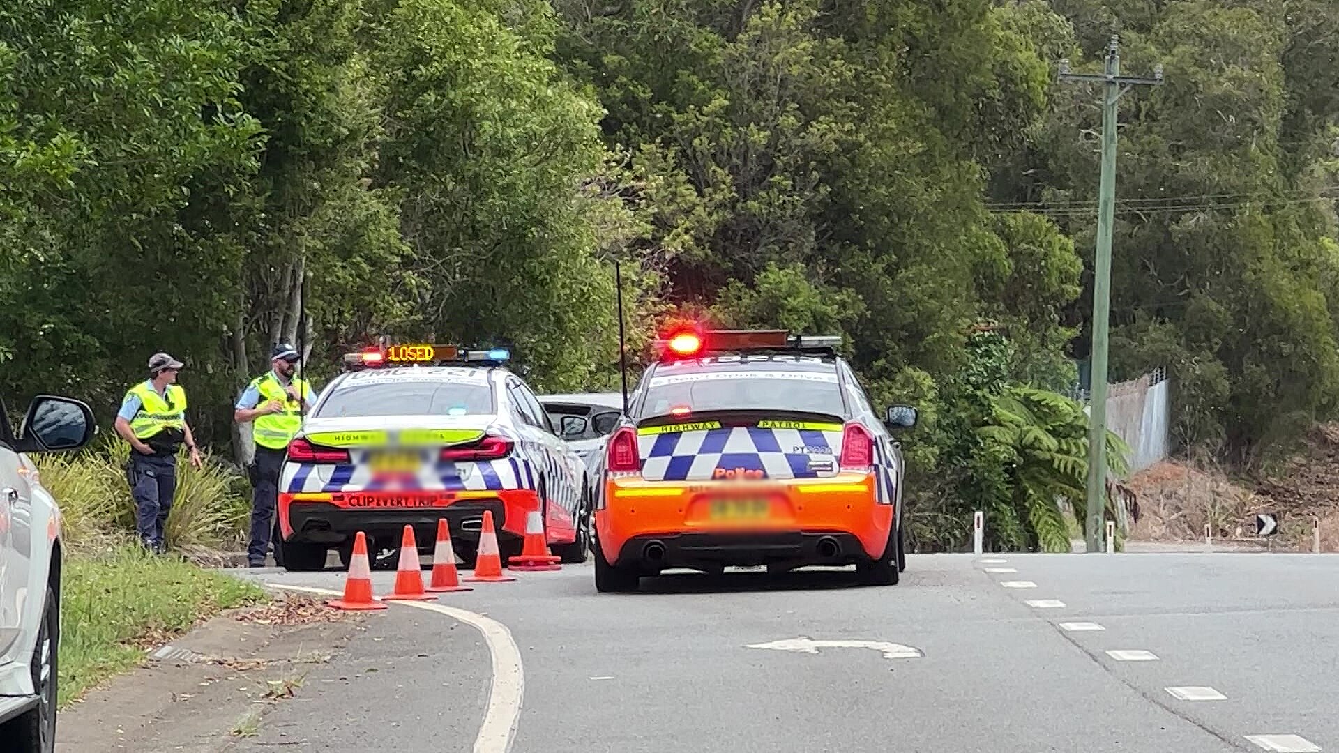 two police cars blocking a road after an incident on the new south wales mid north coast