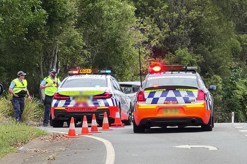 two police cars blocking a road after an incident on the new south wales mid north coast