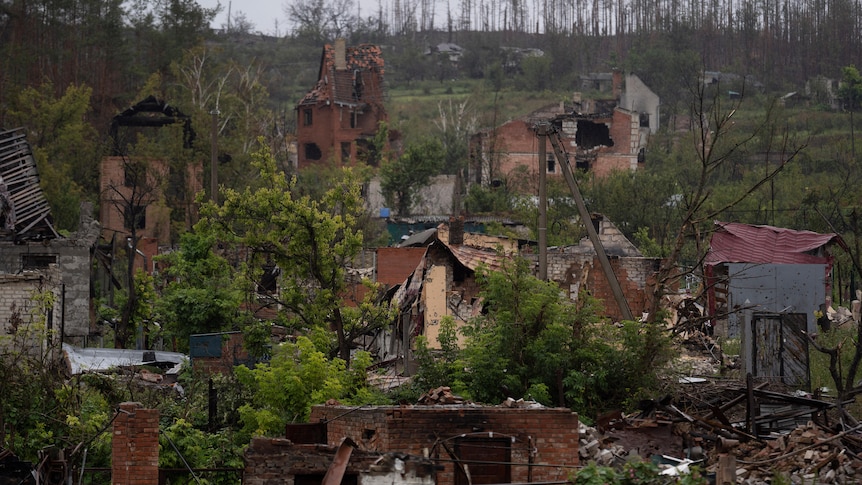 A side of a hill is covered with the debris of houses destroyed in a war