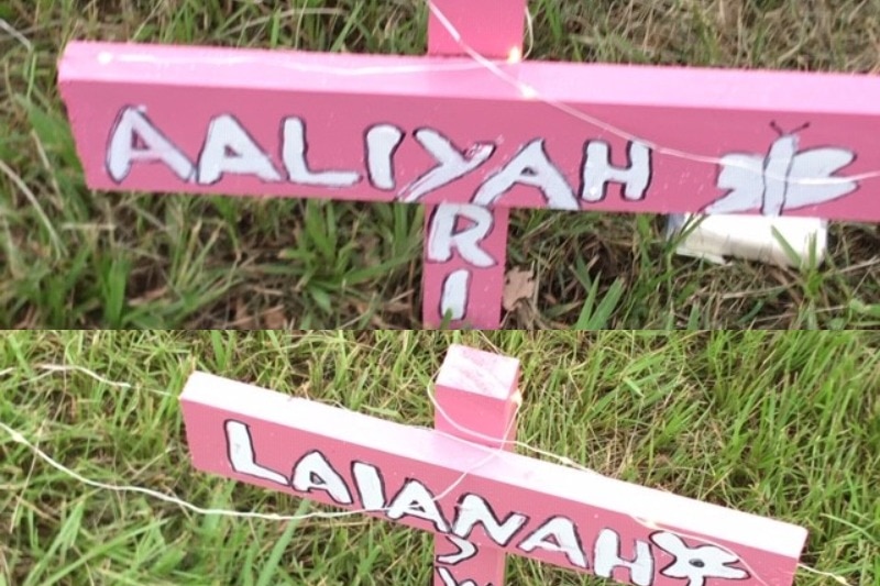 Two pink crosses bearing the names Aaliyah and Laianah