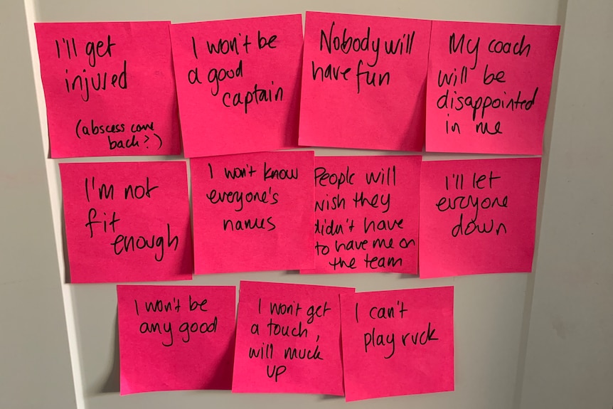An arrangement of pink post-it notes on a wall.