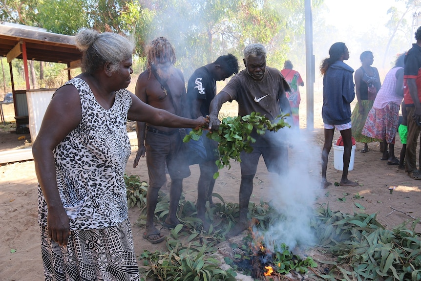 Helen Nyomba Gandangu (L) during a cleansing ceremony at burial site.