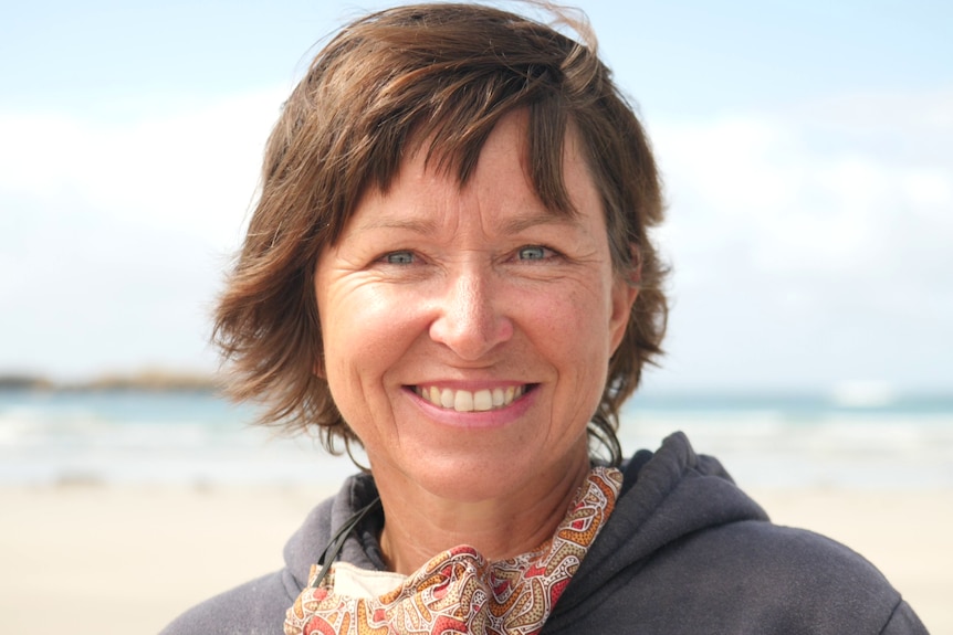 A woman with short hair smiling 