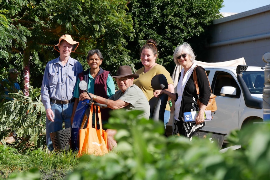 group of people standing in garden