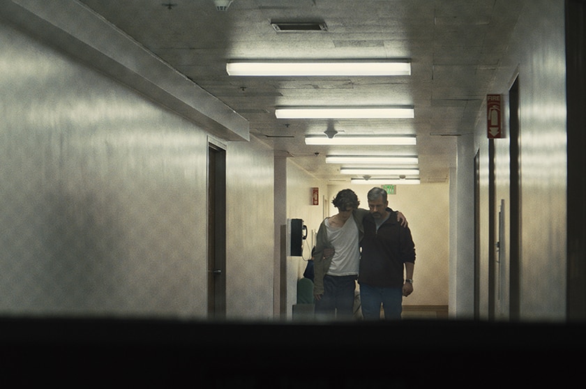 Timothée Chalamet and Steven Carell walking in hallway in Beautiful Boy.