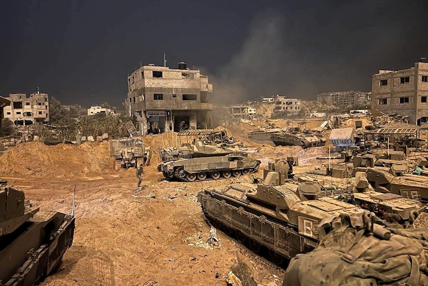 Armoured vehicles of the Israel Defense Forces are seen during their ground operations at a location given as Gaza.