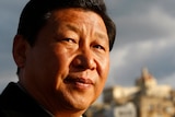 A close up of Xi Jinping's face. He is smiling slightly 