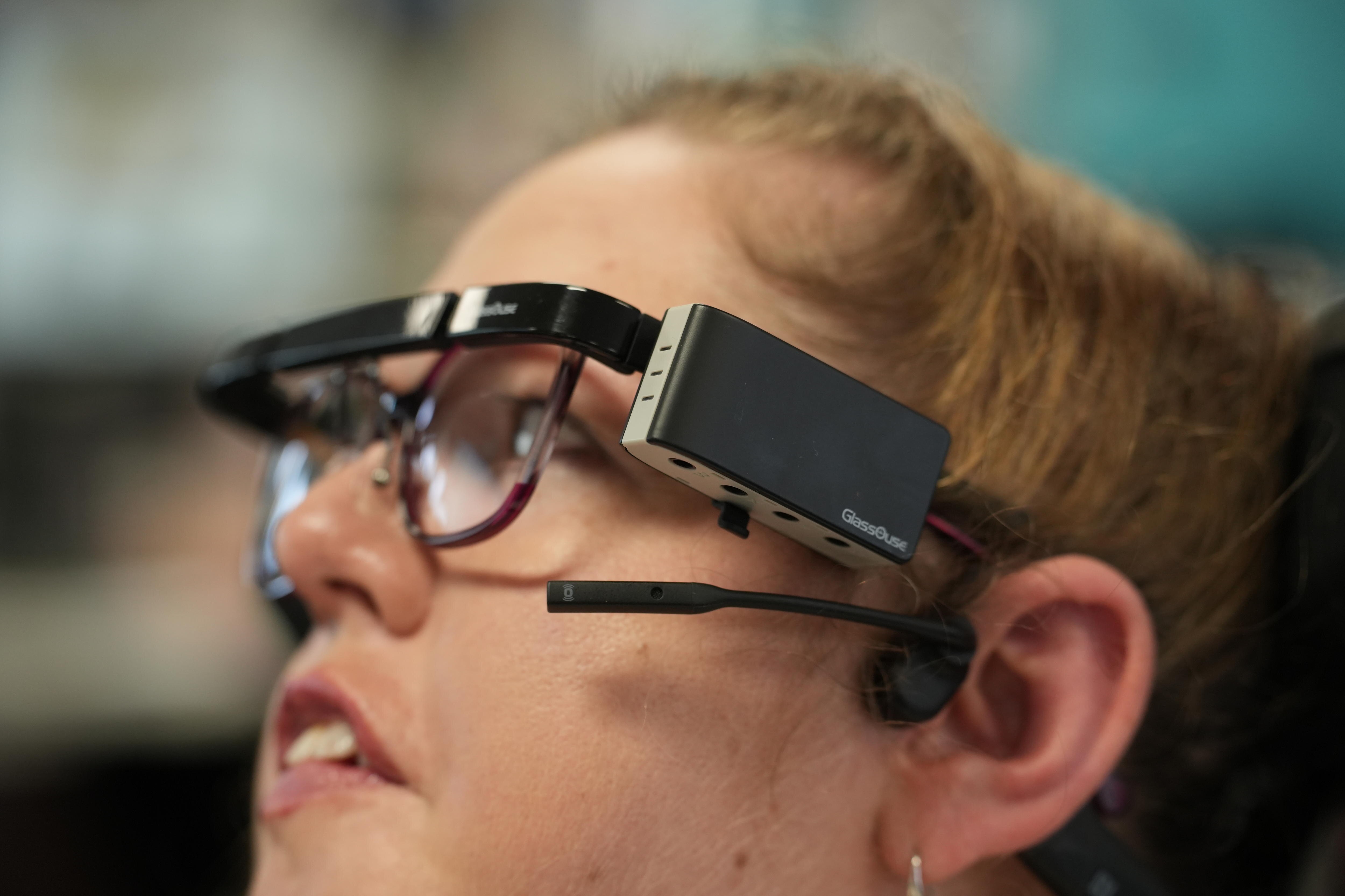 A close relative of an electronic device attached to a woman's glasses.