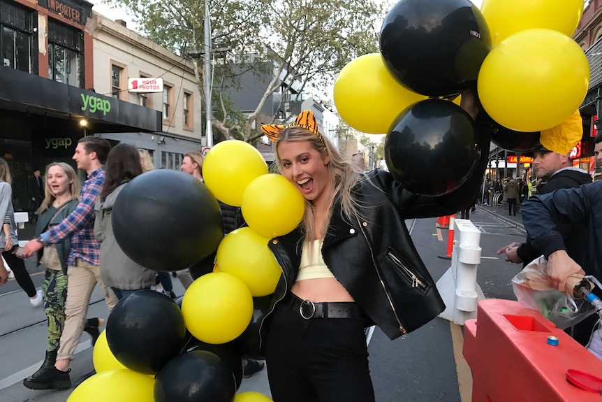 A Richmond fan shows her colours after the Tigers grand final win.