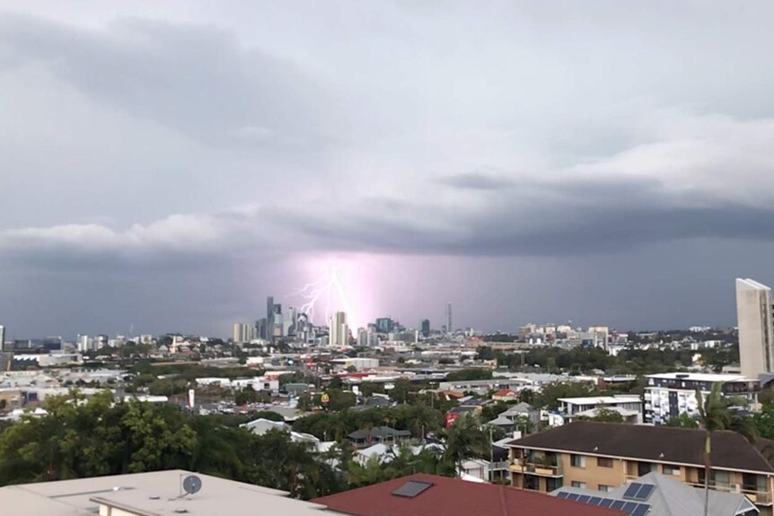 Lightning strikes in sky during storm across the city and houses on Brisbane's northside.