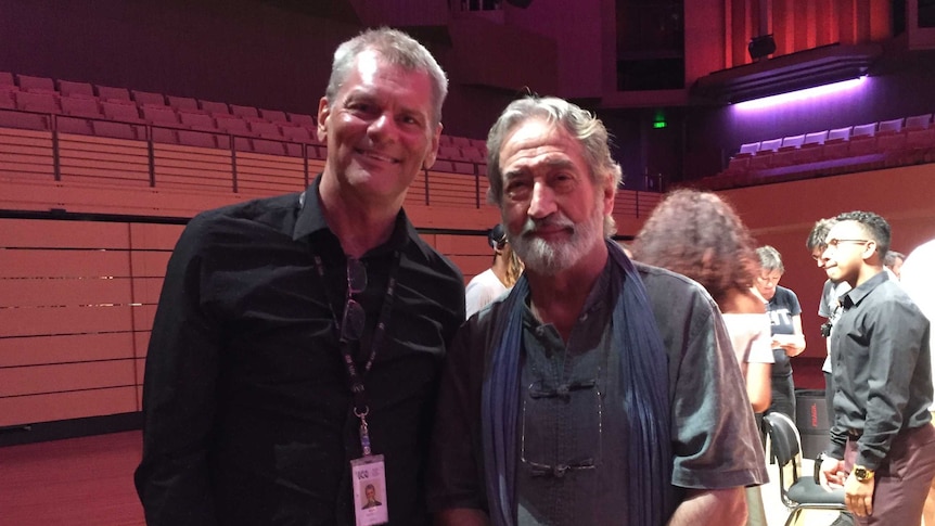 Martin Buzacott standing next to Jordi Savall. Both are smiling at the camera.