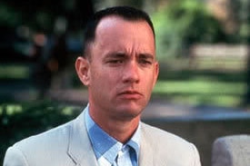 Forrest Gump sits on a bench in a suit