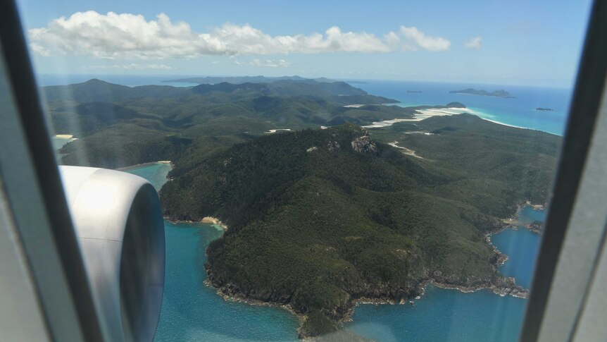 The Whitsunday Islands are seen through the window of a Qantas Boeing 787
