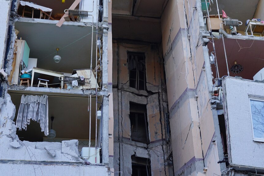 The insides of multiple apartments, after the building's walls were blown off in an attack.