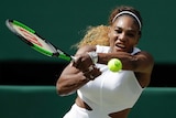 Serena Williams watches the ball as she completes a two-handed shot