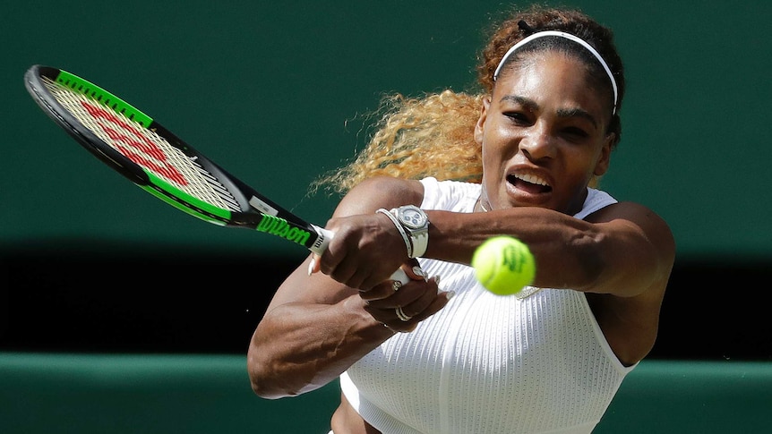 Serena Williams watches the ball as she completes a two-handed shot