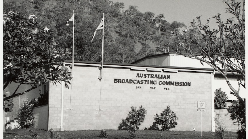 ABC signage on a besser block building face with a flag of Australia and Britain attached as well.