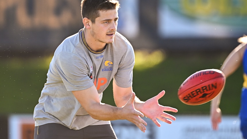 AFL footballer Hamish Brayshaw, receiving a hand pass, during a training session