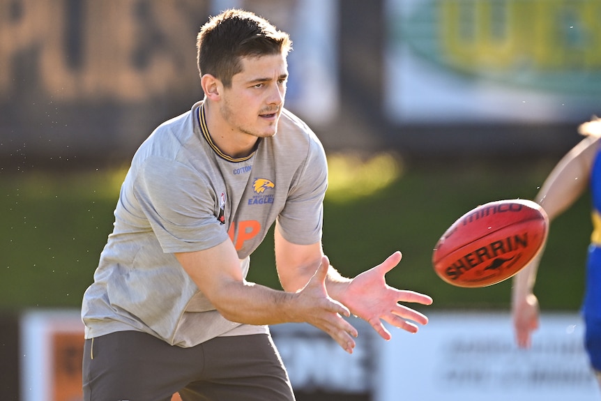 AFL footballer Hamish Brayshaw, receiving a hand pass, during a training session