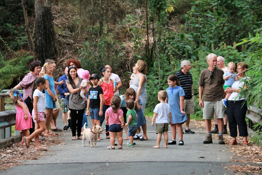 A group of residents stand together on a small bridge in Helensburgh