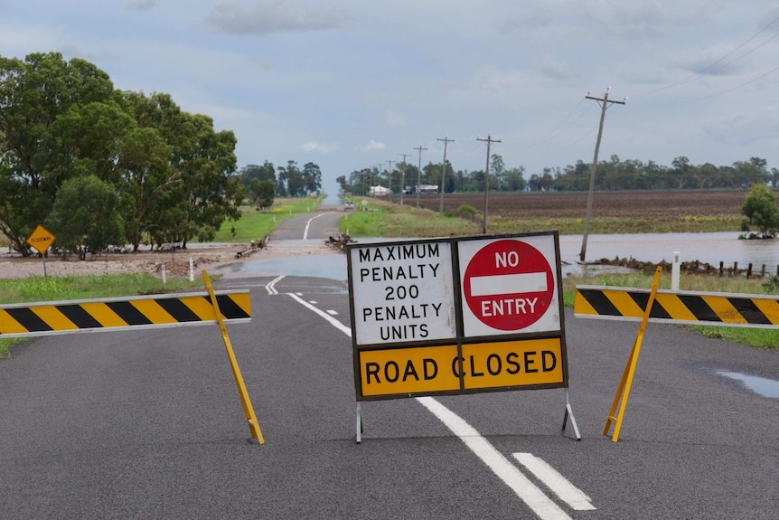 Road closed signs as floodwaters from Jimbour Creek cut off the road to Jandowae.