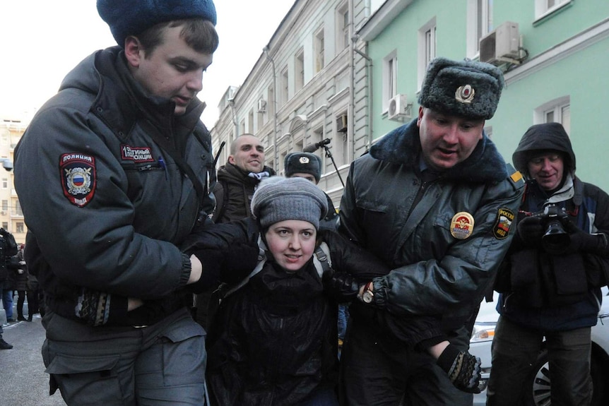 A gay rights activist is detained during a protest outside Russia's State Duma on January 25, 2013.