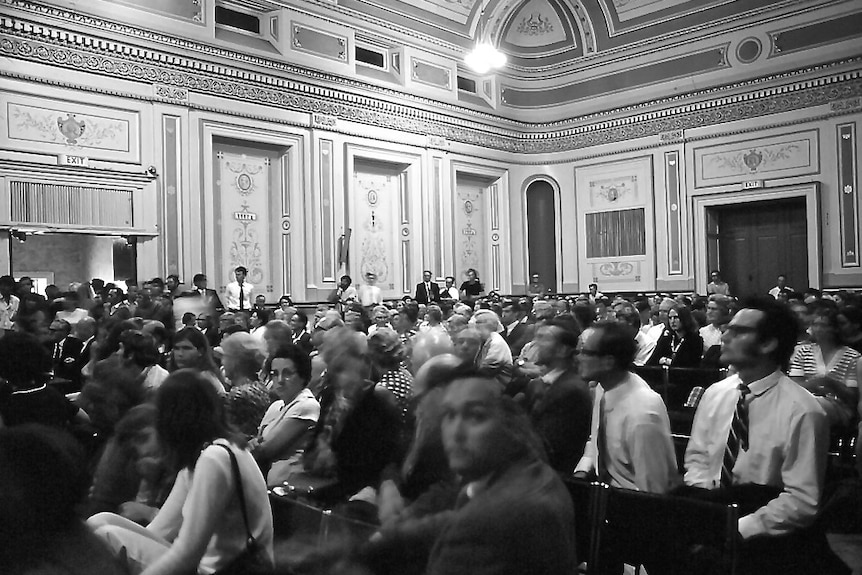 A black and white photo of a crowd of people in Hobart Town Hall.