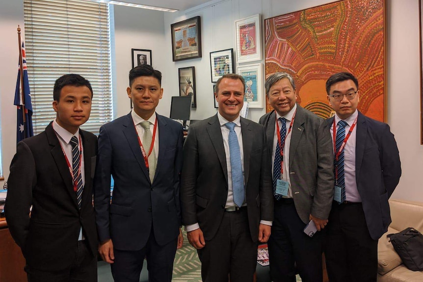 Four Hong Kong pro-democracy leaders pictured with Tim Wilson in an office at Parliament House.