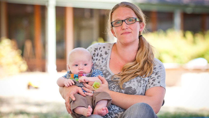 A mother holds her baby son.