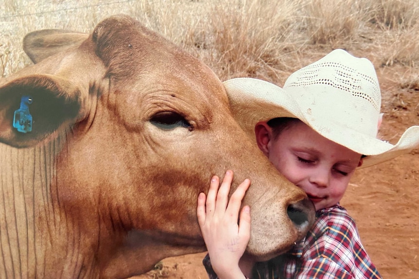 a boy and a cow.