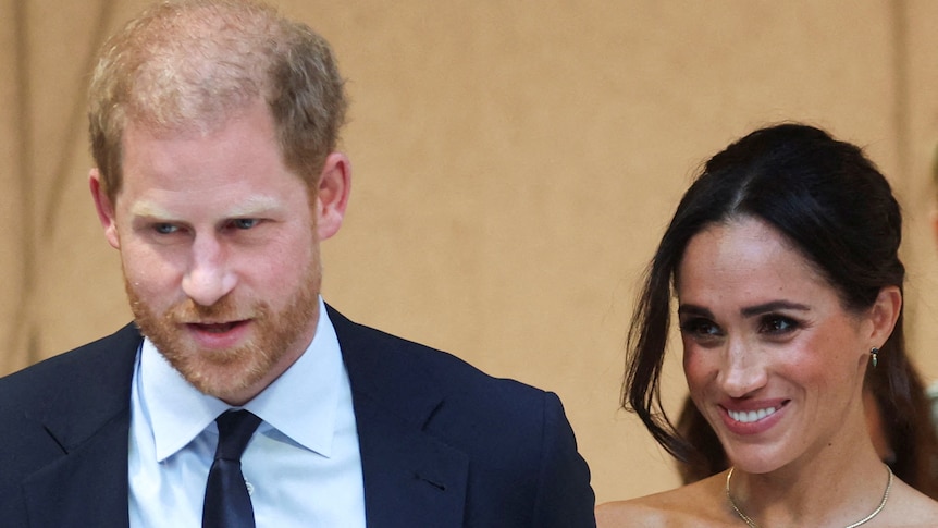 A close up of Prince Harry and Meghan smiling