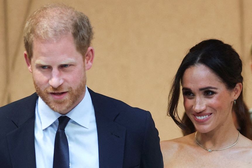 A close up of Prince Harry and Meghan smiling