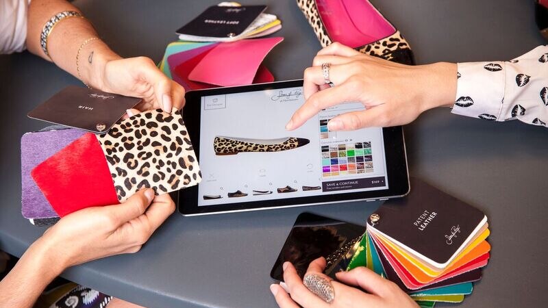 Close-up of leopard print swatches and an iPad with a shoe design.
