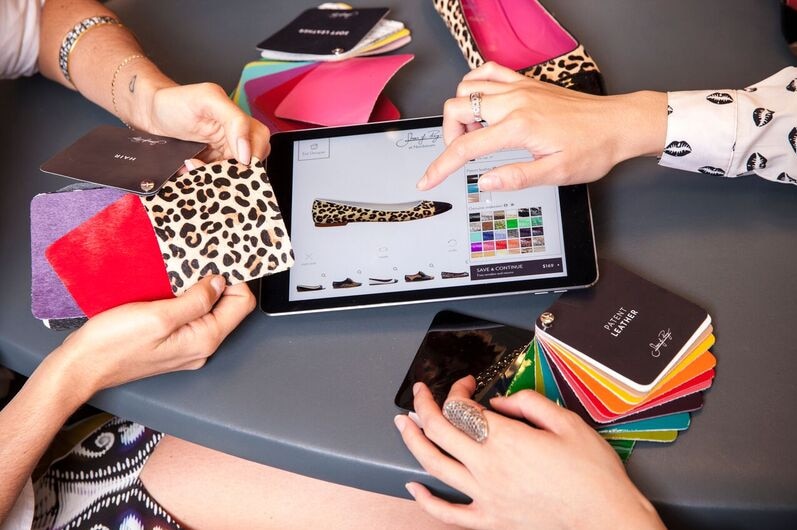 Close-up of leopard print swatches and an iPad with a shoe design.