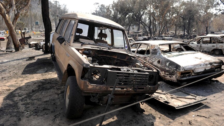 Burnt out car bodies at a property after bushfire swept through Coonabarabran.