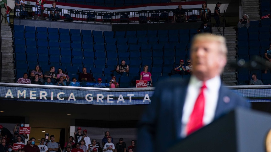 Supporters of President Donald Trump listen as he speaks