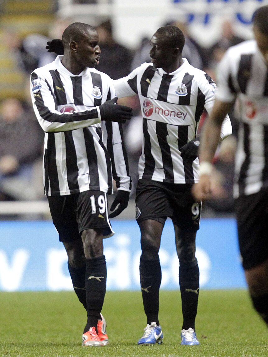 Newcastle United's Demba Ba (L) scored twice to sink 10-man Wigan.