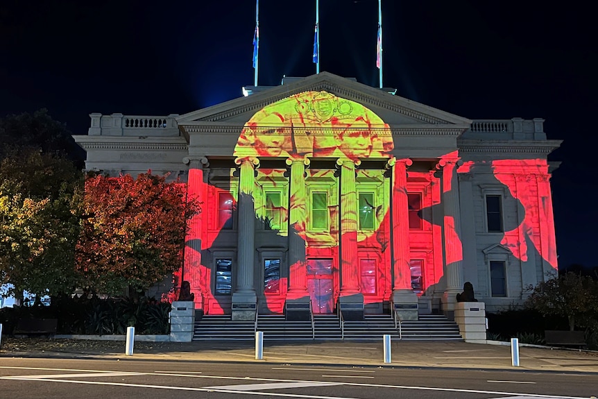 Geelong's town hall emblazoned with a light show featuring the Aboriginal flag.