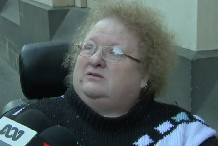 A woman speaks to reporter outside court.