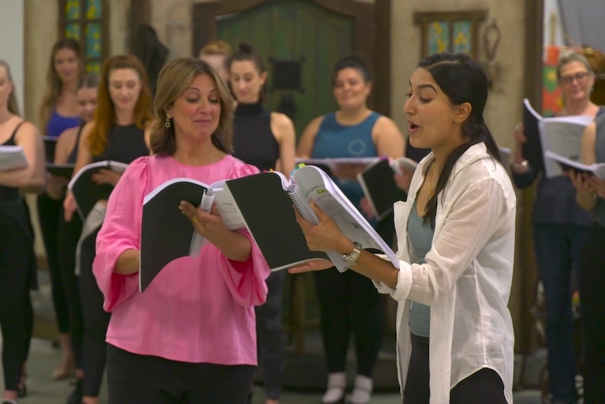 Actors Shubshri Kandiah and Silvie Paladino read from scripts in Cinderella rehearsals